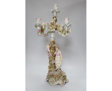 A Sitzendorf-style floral encrusted 4 branch candelabra, 57cms high