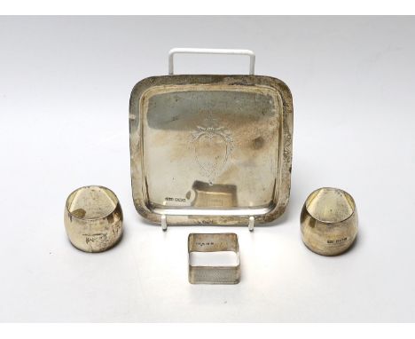 A George V small square silver dish by James Dixon &amp; Sons and three silver napkin rings.