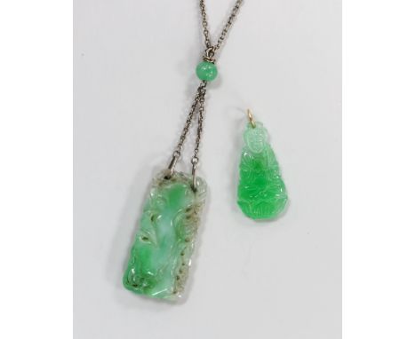 Two carved jade pendants, largest 47mm on a white metal chain.
