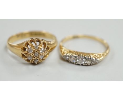 Two early 20th century 18ct and diamond cluster set rings, including graduated five stone, sizes M, gross weight 6.2 grams.