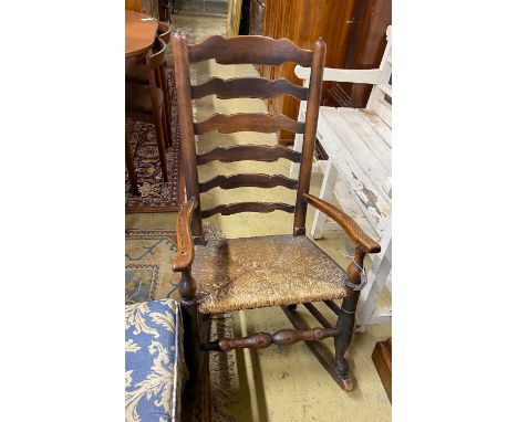 A 19th century Lancashire rush-seated ladder back rocking chair, width 54cm, depth 38cm, height 99cm