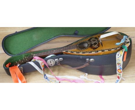 A cased late 19th/early 20th century Italian lute back mandolin with segmented rosewood back and spruce top, eight brass and 