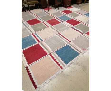 A large Kilim polychrome flatweave carpet of patchwork design, 460 x 370cm