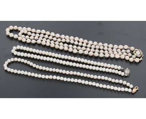 Cultured pearl double strand necklace with a 9ct clasp, the pearls 6-7mm, 50.8gm, 17.5" long approx; with two other pearl nec