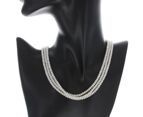 Cultured pearl triple strand necklace with a pearl set yellow metal clasp, the pearls 4mm, 33.5gm, 16" long&nbsp; 