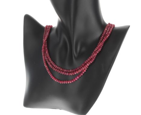 Three row ruby bead necklace, the graduated ruby beads measuring 3mm to mm diameter, beaded section 18" long, to a woven cord