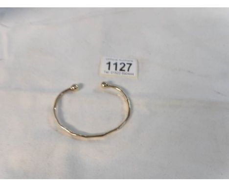 A 9ct gold slave bangle, 13.6 gms