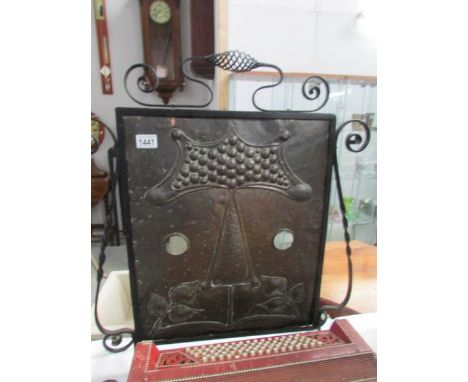 An arts and crafts copper and metal fire screen