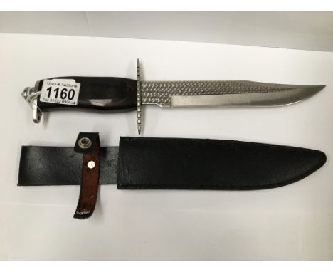 A hunting knife marked 'Stainless China' complete with scabbard