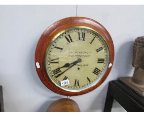 A wall clock with enamel dial 'J.E.Jackson Ltd., 17, Carrington street, Nottingham', with key but missing pendulum