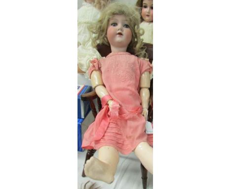 A porcelain headed doll marked 390, A 6 M, 53cm/ 21", some damage to body