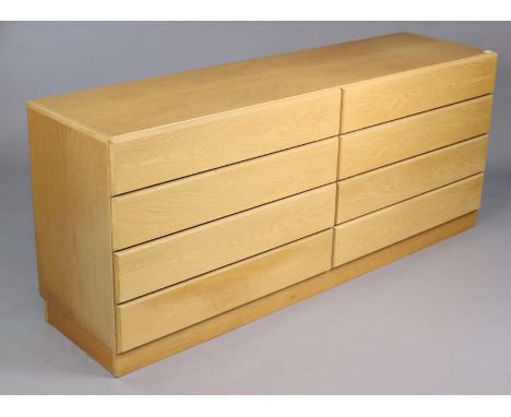 A Vitzo (Danish) light oak sideboard fitted two ranks of four long drawers, and on a plinth base, 67½” long x 28½” high x 17¼