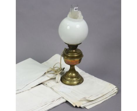 A brass oil table lamp converted to electricity (the globular opaque glass shade cracked); together with four white damask ta