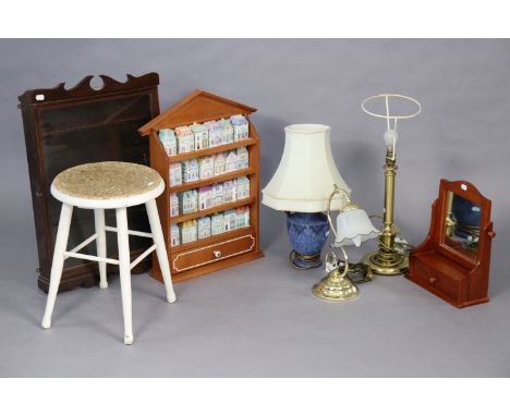 A spice-rack with twenty-four novelty “house” spice jars; together with a wall cabinet; a milking stool; four table lamp base