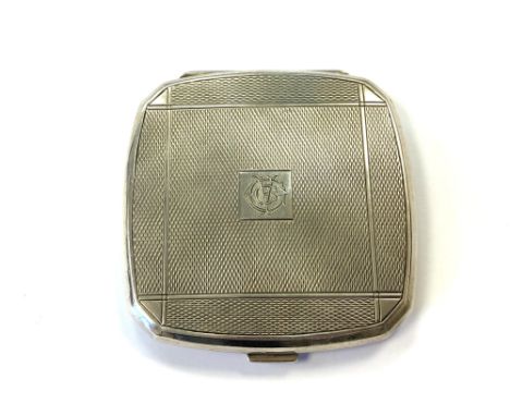 An Art Deco silver compact with engine turned decoration 
