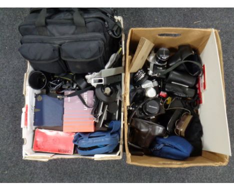 Two boxes of camera equipment and cameras by Olympus, Zenit, Praktica, Pentax, lens, slide duplicator, camera bag etc 