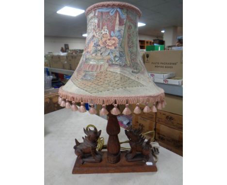 An Eastern wooden table lamp with tassel shade 