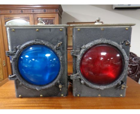 Two vintage railway signalling lamps with red and blue lenses 