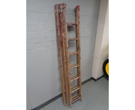 A triple wooden extension ladder 