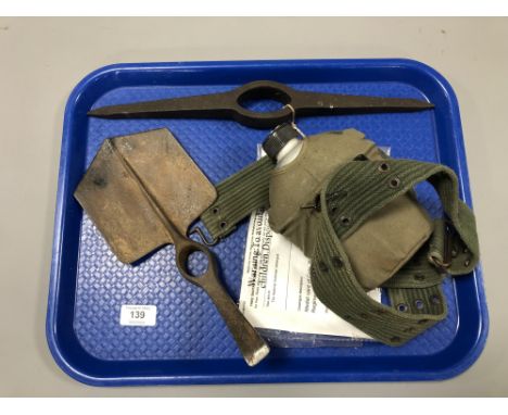 A military entrenching tool head, a pick axe head and a military water canteen 