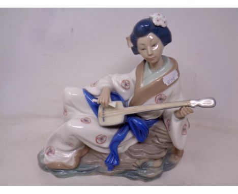 A Nao figure of a Geisha playing a stringed instrument 