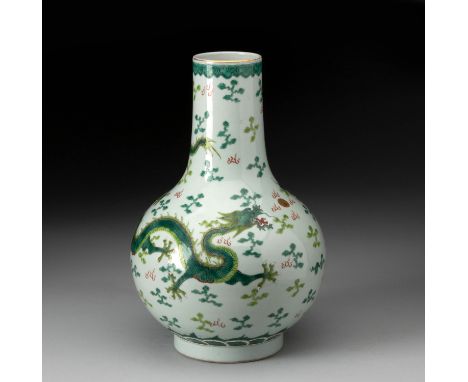 Enamelled in rich translucent green with two five-clawed dragons meandering amongst clouds in pursuit of a gilded pearl above