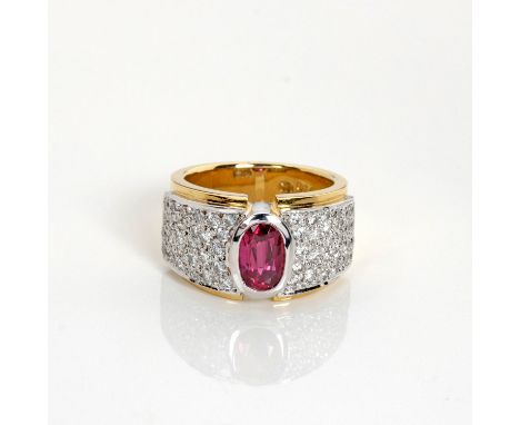 The broad tapered band bezel set to the centre with an oval mixed-cut ruby weighing approximately 0.88cts, the shoulders pavé