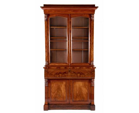 A VICTORIAN MAHOGANY SECRETAIRE BOOKCASEIn two parts, the outswept cornice above a plain frieze, a pair of arched glazed door