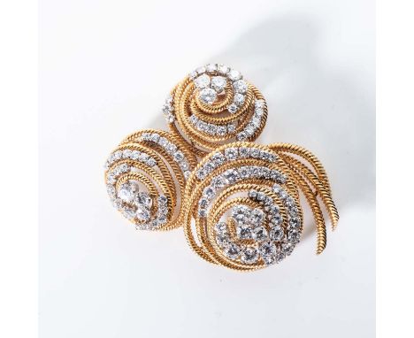 Designed as a stylised floral spray with three domed spiral motifs composed of coiled wire and embellished with ninety round 