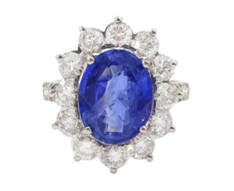 18ct white gold oval sapphire and round brilliant cut diamond cluster ring, with diamond set shoulders, stamped 18K, sapphire