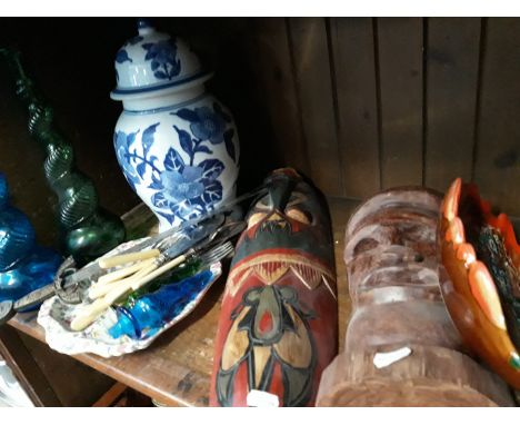 Shelf of items inc. carved wood, blue vase and cover, glass etc. 