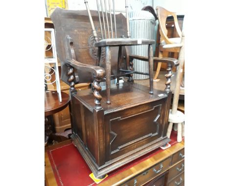 An oak monk's type bench seat with fold over top, width 62cm, depth 52cm &amp; min. height 73cm. 