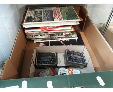 A box of books and a box of vintage tins 