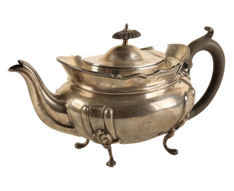 A GEORGE V SILVER OVAL TEAPOT by William Aitken, Birmingham 1920, the squat body with ebonised finial and handle, on four spl