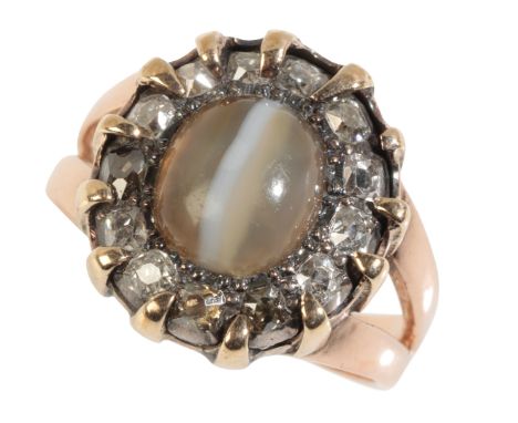 A TIGERS EYE AND DIAMOND CLUSTER RING on a 15ct yellow gold shank, with openwork shoulders, ring size N