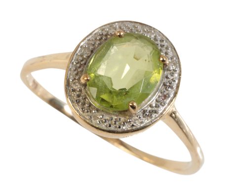 A PERIDOT AND DIAMOND CLUSTER RING on an unmarked yellow gold shank, ring size S