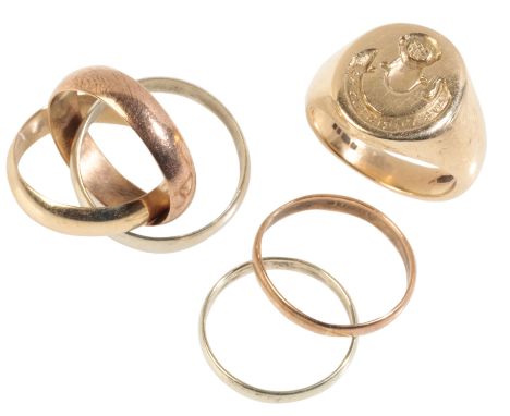 A 9CT GOLD CRESTED SIGNET RING together with two 9ct gold wedding bands, (c.8.1grams total weight), and an unmarked tri-colou