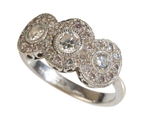 A TRIPLE CLUSTER DIAMOND RING the central diamond (c.0.20ct), on a white gold shank stamped "750", ring size J-K