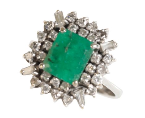 AN EMERALD AND DIAMOND CLUSTER RING (one diamond missing, one replaced stone not diamond), on an unmarked white metal shank, 