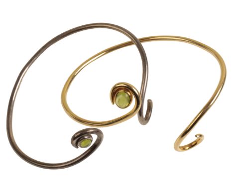 A 14CT GOLD BANGLE SET WITH PERIDOT weighing approximately 17g, together with a similar silver example.