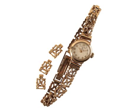 FAVRE LUEBA: A LADY'S 9CT GOLD BRACELET WATCH with manual wind movement,  the silver dial with gold Arabic  numerals and gold