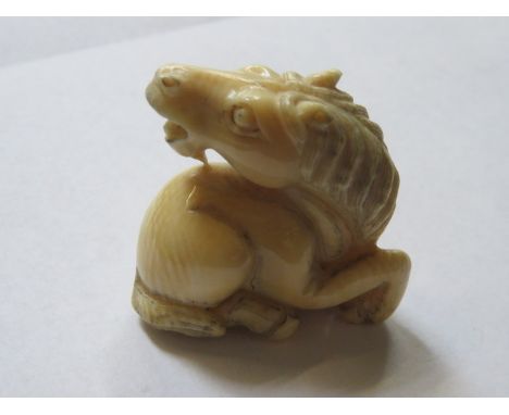 HEAVILY CARVED ORIENTAL IVORY NETSUKE OF A STYLISED HORSE, APPROXIMATLEY 5cm HIGH