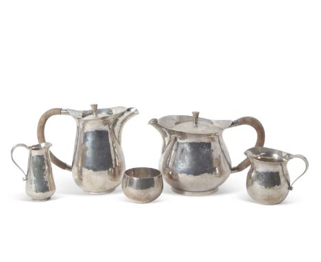 Sterling Silver Modernist tea service. comprising Teapot, Hot water jug, Sugar bowl, Cream and Milk jug, having overall light