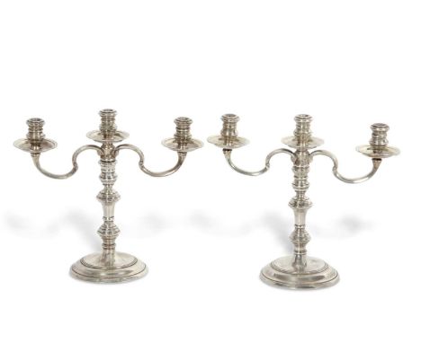 A pair of small silver three light candelabra in Queen Anne style, the three lights are removeable to leave a plain tapered s