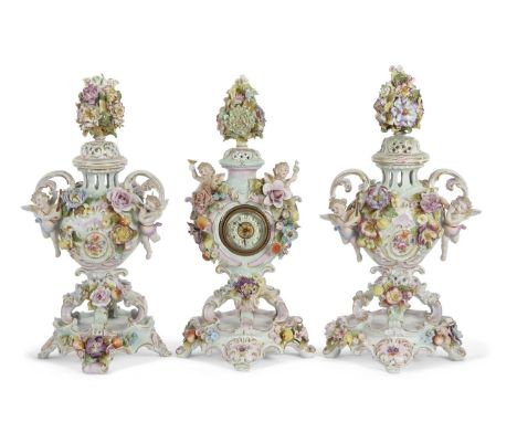 A garniture of late 19th Century continental porcelain pot pourri vases with applied floral and cherub decoration together wi