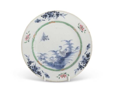 An 18th Century Chinese porcelain plate decorated in Kangxi style with a blue and white design of birds to the centre within 