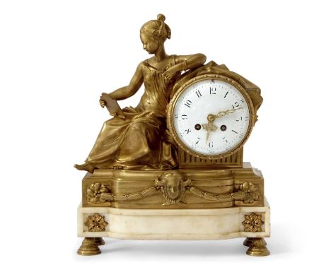 A French 19th Century gilt brass mantel clock with white enamel dial to a brass movement, the case with a figural mount forme