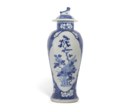 A 19th Century Chinese porcelain  vase and cover, the blue ground decorated with prunus and panels of finely painted flowers 