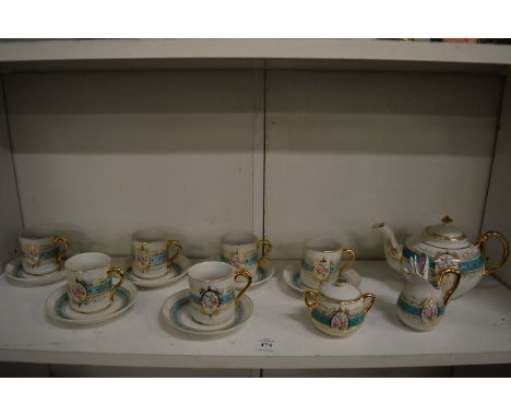 A child's six place porcelain tea service including six miniature metal spoons.