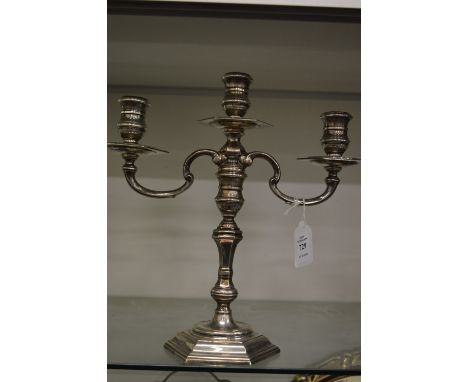 A cast silver three light twin branch candelabra with detachable top section.